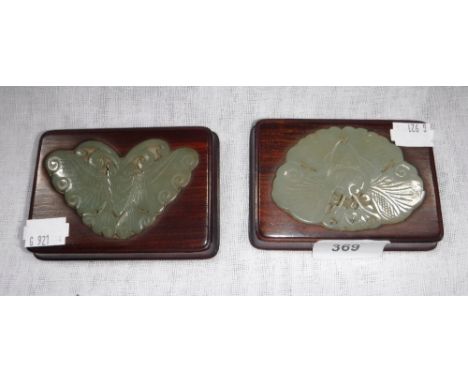 A PAIR OF ORIENTAL JADE PAPERWEIGHTS, the carved jade inset into hardwood bases