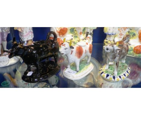 THREE CERAMIC COW CREAMERS 