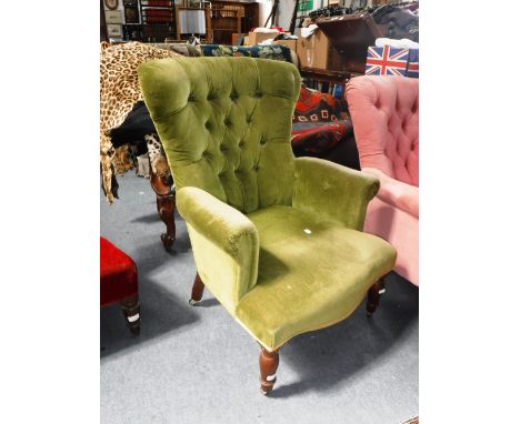 A VICTORIAN BUTTON BACK ARMCHAIR upholstered in green velvet
