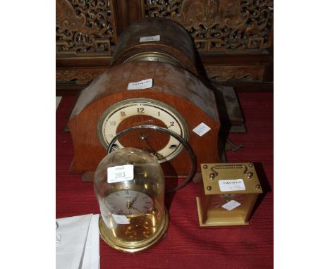 A brass Kundo 400-day clock under glass dome, 18cm high, two wood cased chiming mantel clocks and a battery clock, (4).