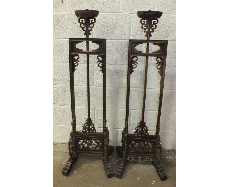 A pair of Chinese carved hardwood adjustable lamp stands, 137cm high, 188cm maximum, (one with damage to carving), (2).
