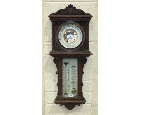 A Maple & Co. walnut aneroid barometer, the architectural form case with circular ceramic dial and visible barometer movement