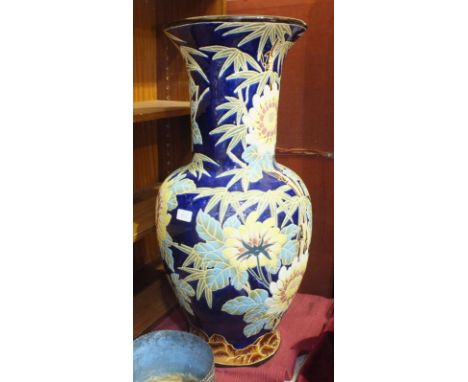 A large ceramic baluster vase decorated with flowers, 79cm high.