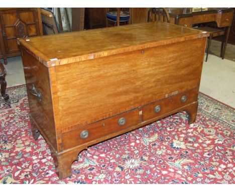 A mahogany cross-banded blanket chest, the lift lid above two base drawers on bracket feet, 133cm wide, 83cm high, (in need o