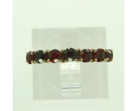 9ct gold ring set with seven garnets, size N, 1.3g. UK P&amp;P Group 0 (£6+VAT for the first lot and £1+VAT for subsequent lo