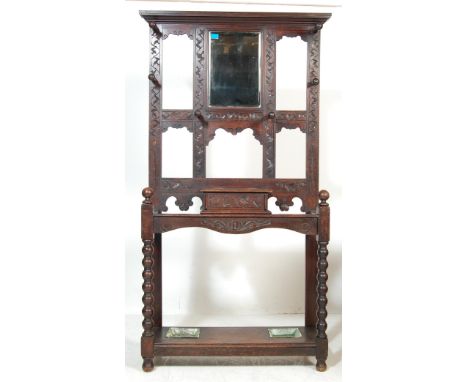 A Victorian 19th century carved oak hall stand / coat stand. The upright stand with central bevelled mirror to the centre fla