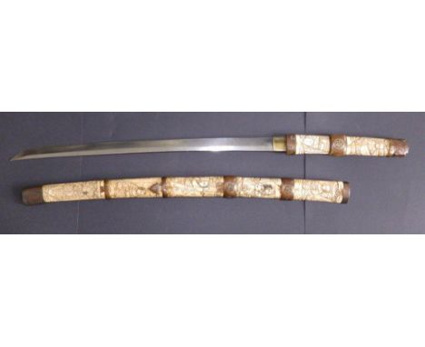 A Japanese wakazashi in carved bone scabbard,  30” overall 