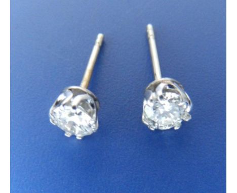 A pair of diamond stud earrings of total weight approximately .75 carat, in white metal testing as 18ct  gold 