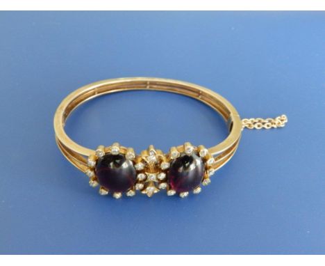 A garnet & diamond set bangle of twin cluster form SEE ILLUSTRATION