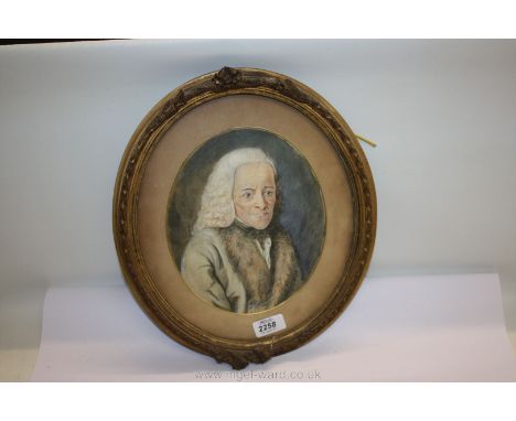 An early gouache portrait of the French philosopher Voltaire in an oval gilt frame