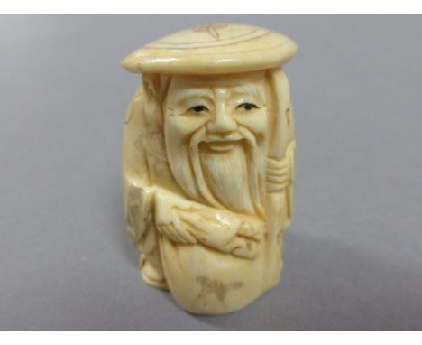 Signed oxbone netsuke of an old man with sack