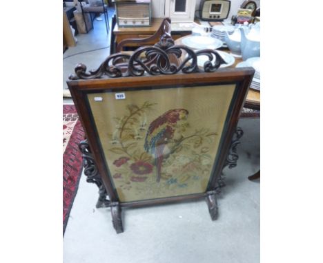 19th century Mahogany Fire Screen with Scroll Carved Panels and a Needlework Panel depicting a Parrot