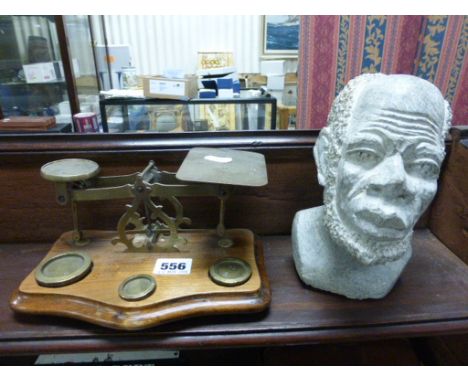 Vintage postage scales complete with weights plus a stone figure of a black mans head