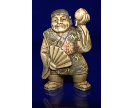 A Meiji Period Stained Ivory Netsuke Of A Man Holding A Peach, Signed To Base With Red Signature 