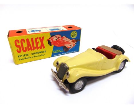 A SCALEX M.G.TF  cream with red seats and a brown tonneau cover, with a push-down pull-back mechanism (not tested), near mint