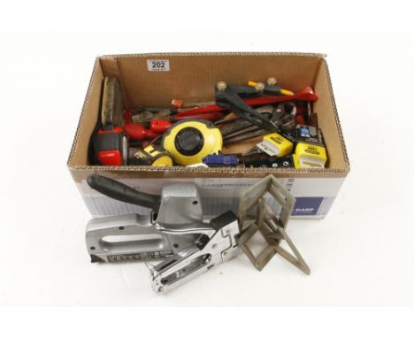 Two staple guns a quantity of tape measures and other tools
