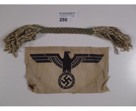 a WW2 German Army sport shirt eagle with Swastika in talons & 1 double ended tassel type object, exact use unknown