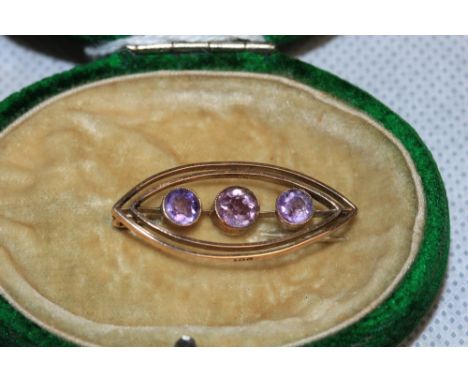 A 9ct three stone amethyst brooch and a plated fob seal