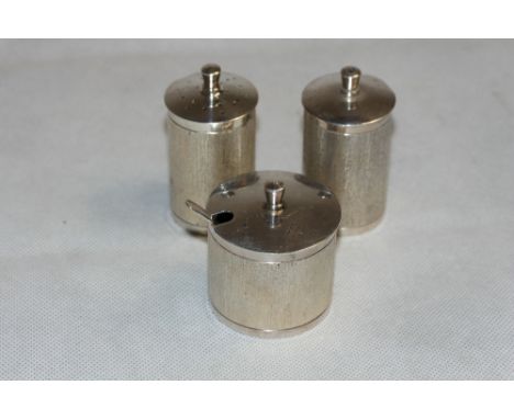 A modernist silver three piece cruet with engine turned 'frosted' decoration. Maker: JBC & S. Birmingham 1973. 6ozs 10dwts