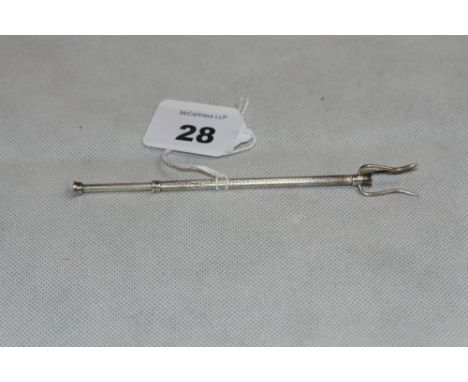 A silver pickle fork with engine turned decoration. Birmingham 1961