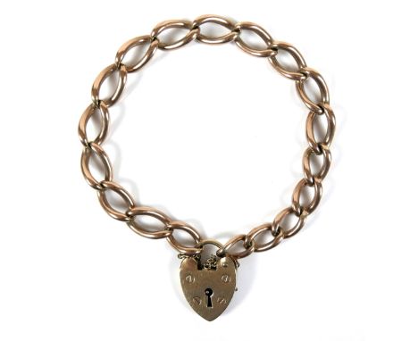 A 9ct yellow gold curb link bracelet, with heart shaped padlock clasp and safety chain, 0.9 by 16cm long, 27.4g. 