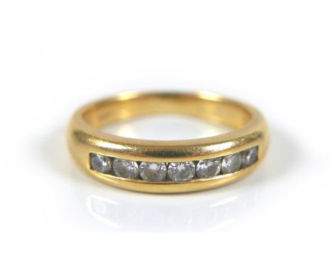 An 18ct gold and diamond quarter eternity ring, with seven round brilliant cut diamonds, size K, 4.83g 