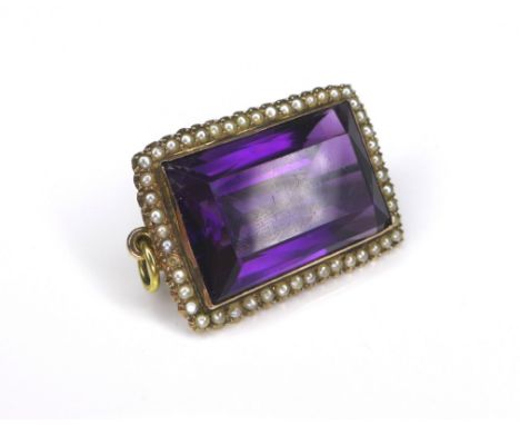 A large amethyst and seed pearl brooch with yellow metal mount, 13.6g overall, the rectangular cut amethyst 2.5 by 1.7cm, ove