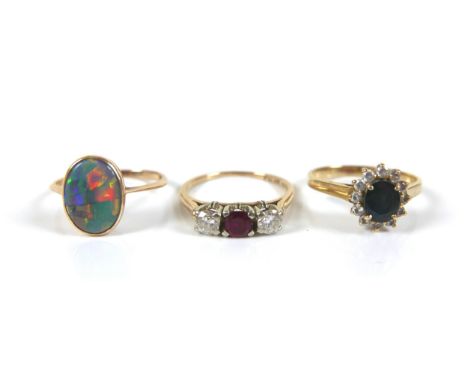 A group of three gold rings, comprising a 14ct and 18ct gold diamond and ruby three stone ring, each round cut stone 3.5mm, s