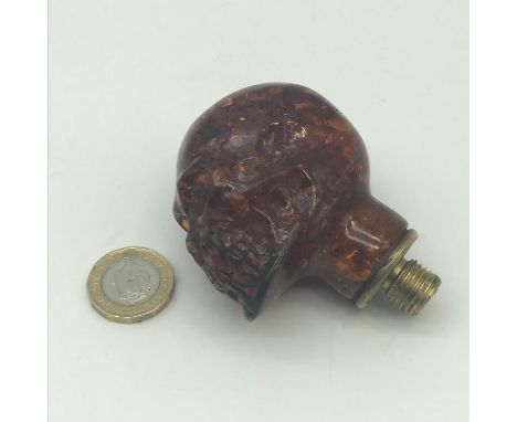 An antique skull carved head handle for a walking stick, Possibly amber. 