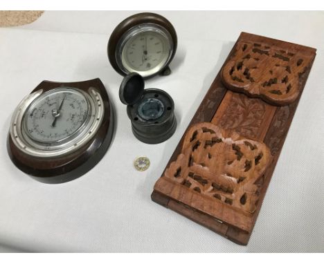 An assortment of odds to include Military ink well pot, Two barometers and a carved sliding book shelf. 