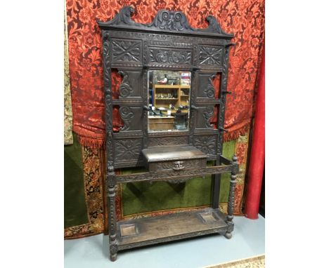 A Large Victorian highly carved hallway coat/ stick stand, Centred with a rectangle bevel edge mirror, Measures 230x120x35cm 