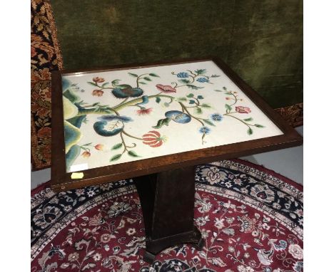 Antique flip top table/ firescreen, designed with a floral tapestry behind glass. Table top measures 64x54cm 