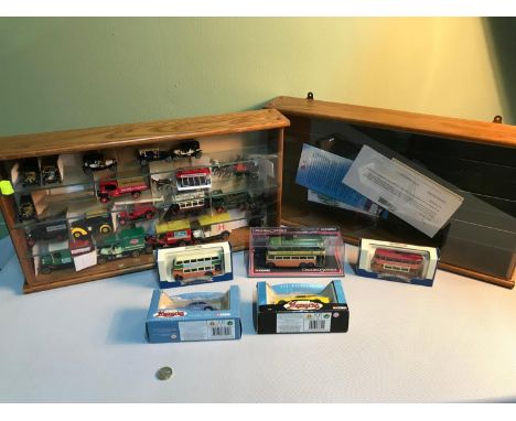 Two wood, glass and perspex display cabinets one partially filled with car and lorry models together with boxed bus and car m