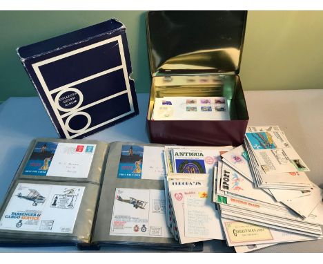 An album and tin filled with first day covers 