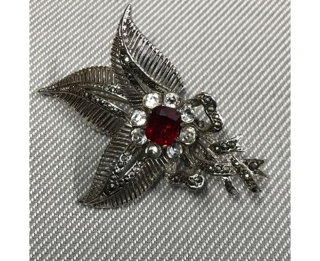 A London silver Fern brooch designed with a large Ruby stone, surrounded by clear stones 