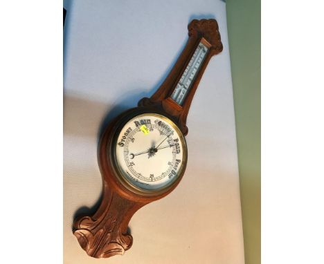 A Victorian solid oak wall Aneroid barometer, ceramic face and mercury Thermometer, Measures 84cm in height 