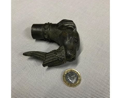 A Bronze walking stick top in the design of a gun dog holding a pheasant in its mouth. 