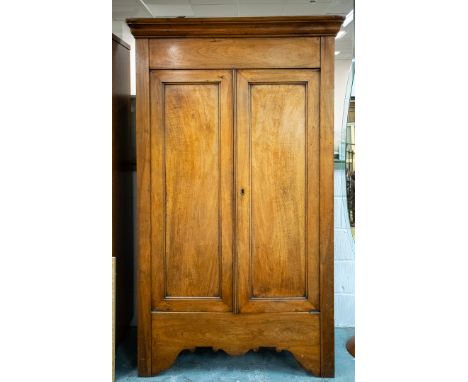 MID 19TH CENTURY CONTINENTAL ARMOIRE. Walnut with two doors enclosing a shelf and hanging rail, 206cm H x 124cm W x 51cm D.