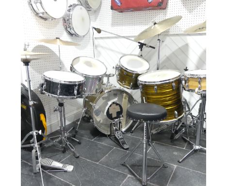 A custom Drum Kit, comprising of a Gretsch bass drum, floor tom, high tom and low tom, Pearl Piccolo, Premier snare drum, Yam