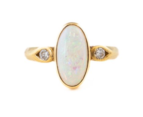 AN OPAL AND DIAMOND RINGFeaturing an oval opal, in a bezel setting, with a round brilliant cut diamond on each side, in 18ct 