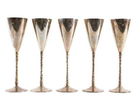 FIVE STUART DEVLIN SILVER WINE GOBLETS (5)Each with a tapered bowl, raised from a decorated stem on a domed circular foot, on