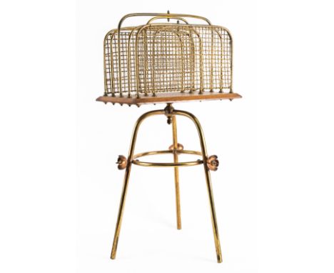 AN EDWARDIAN BRASS AND COPPER MOUNTED OAK CANTERBURY OR MAGAZINE RACKEarly 20th Century 
With four divisions and rotating, th