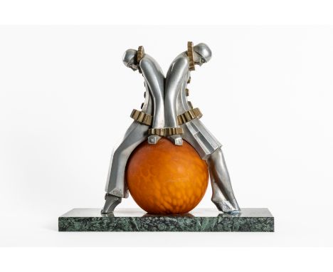 AN ART DECO ALUMINIUM AND BRASS ‘PIERROT’ TABLE LAMPCirca 1920 
Inscribed to the cast ‘EXE 3’, with an orange mottled globula