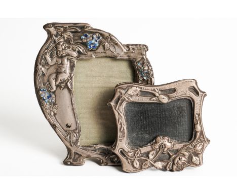 TWO SILVER MOUNTED SMALL PHOTOGRAPH FRAMES (2)The larger decorated with a putto seated amongst flowers, in an Art Nouveau sha