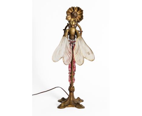 AN ART NOUVEAU GILT-BRASS AND FROSTED GLASS TABLE LAMP IN THE FORM OF A DRAGONFLY AND FLOWEREarly 20th Century Modelled as a 