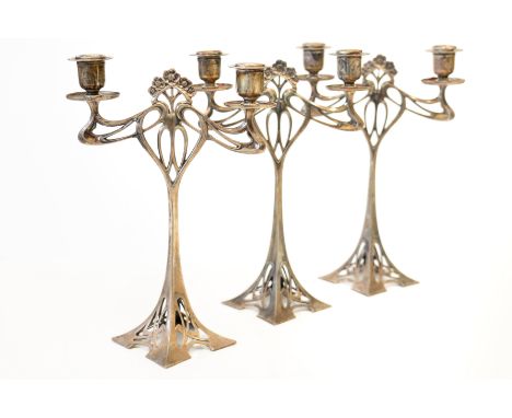 A GARNITURE OF THREE W.M.F PLATED TWIN LIGHT TABLE CANDELABRA (3)Each of pierced openwork Art Nouveau design, with floral mot