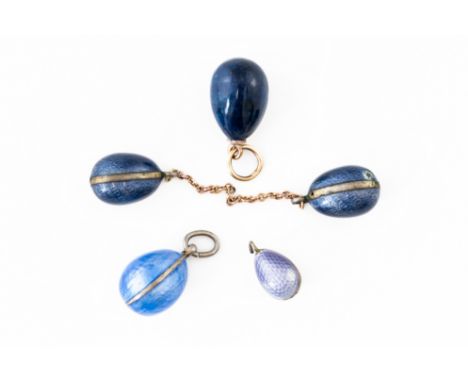 A GROUP OF FIVE BLUE EGG CHARMS (5)Of varying sizes, including a pale blue enamel egg, a lapis lazuli egg, and three other sm