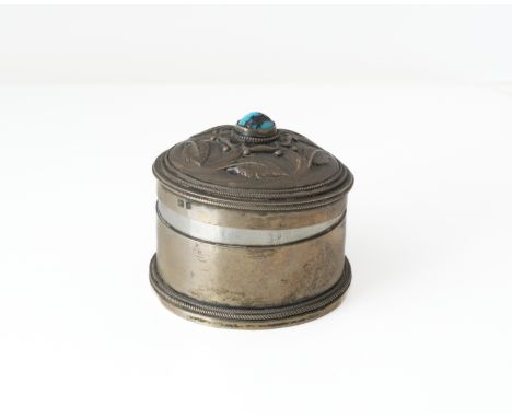 A LIBERTY AND CO SILVER AND TURQUOISE MATRIX HINGE LIDDED TRINKET BOXOf circular form, the domed cover centred by a turquoise