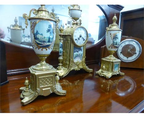 DECORATIVE BRASS CASED CLOCK GARNITURE the enamelled clock dial with Roman numerals, set in ornate case with ceramic supports