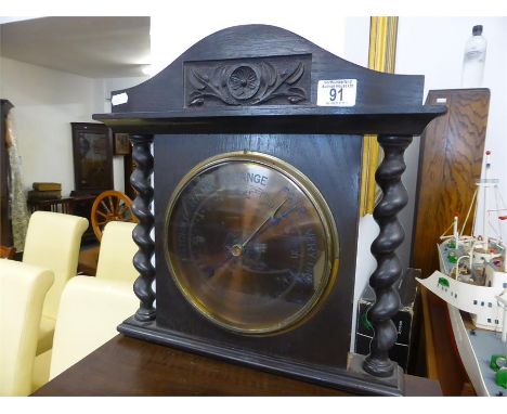 BRASS FACED ANEROID WALL BAROMETER set in carved wood surround